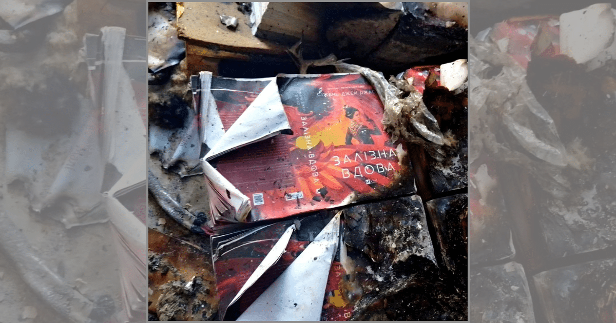 Авторът на романа “Желязната вдовица”, Сизжан Джей Жао,  показва изгорялата корица на книгата си в печатница в Харков.